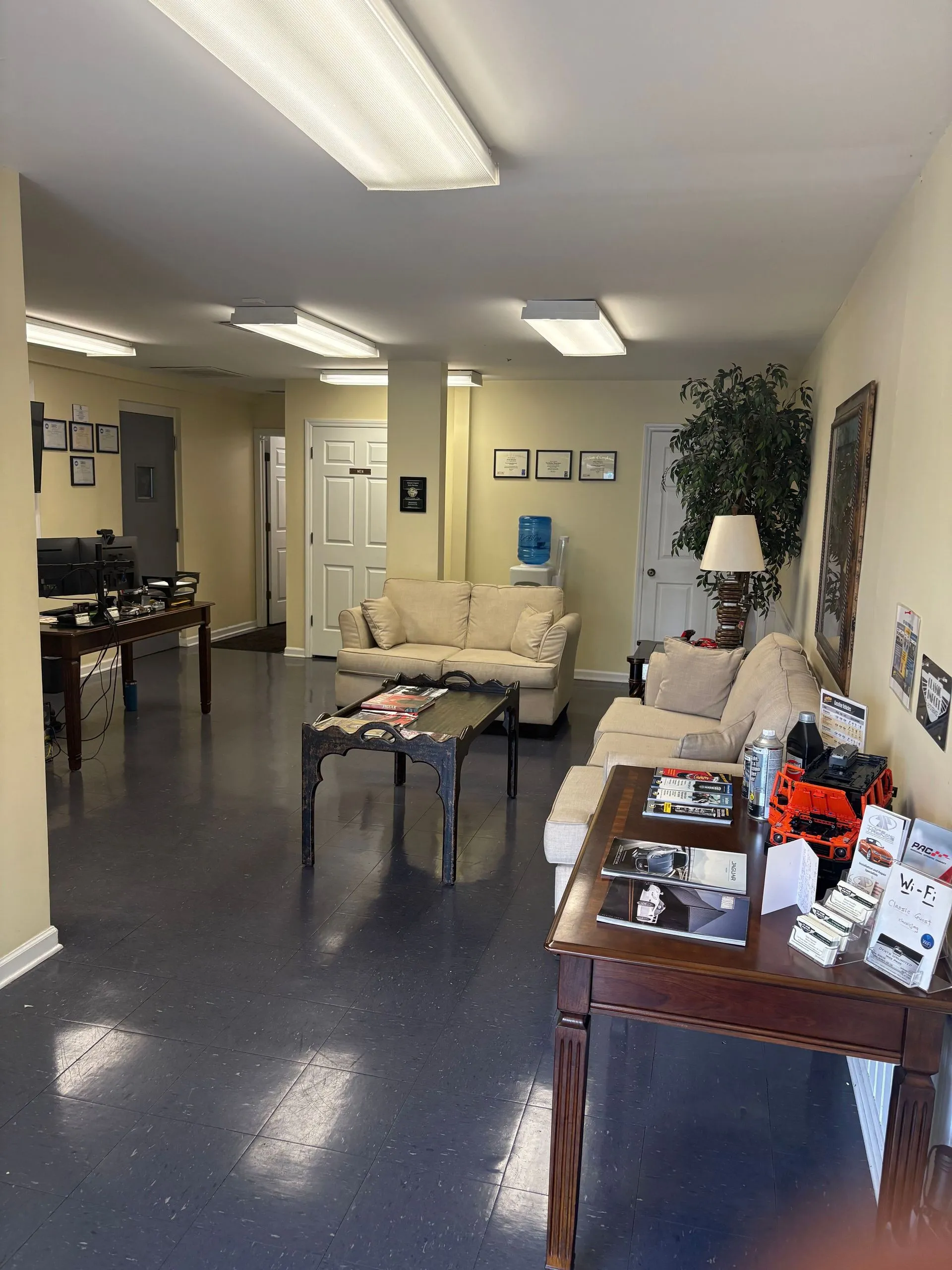 Waiting area with couches, coffee tables, and framed wall decor